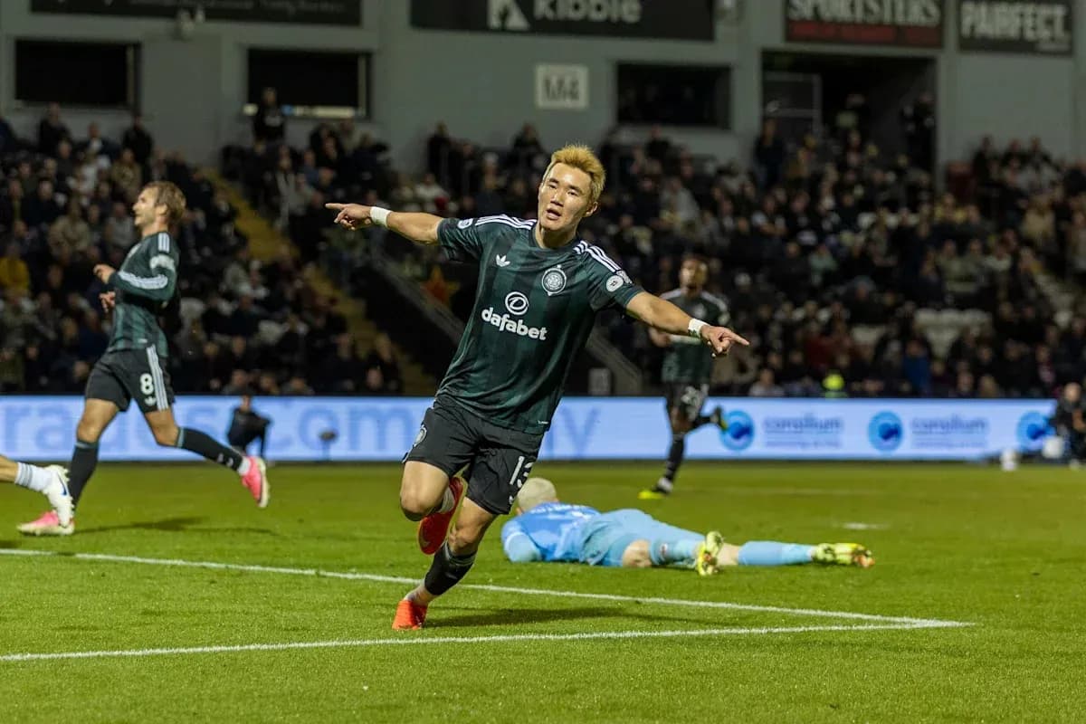 Player celebrating a goal with teammates in match