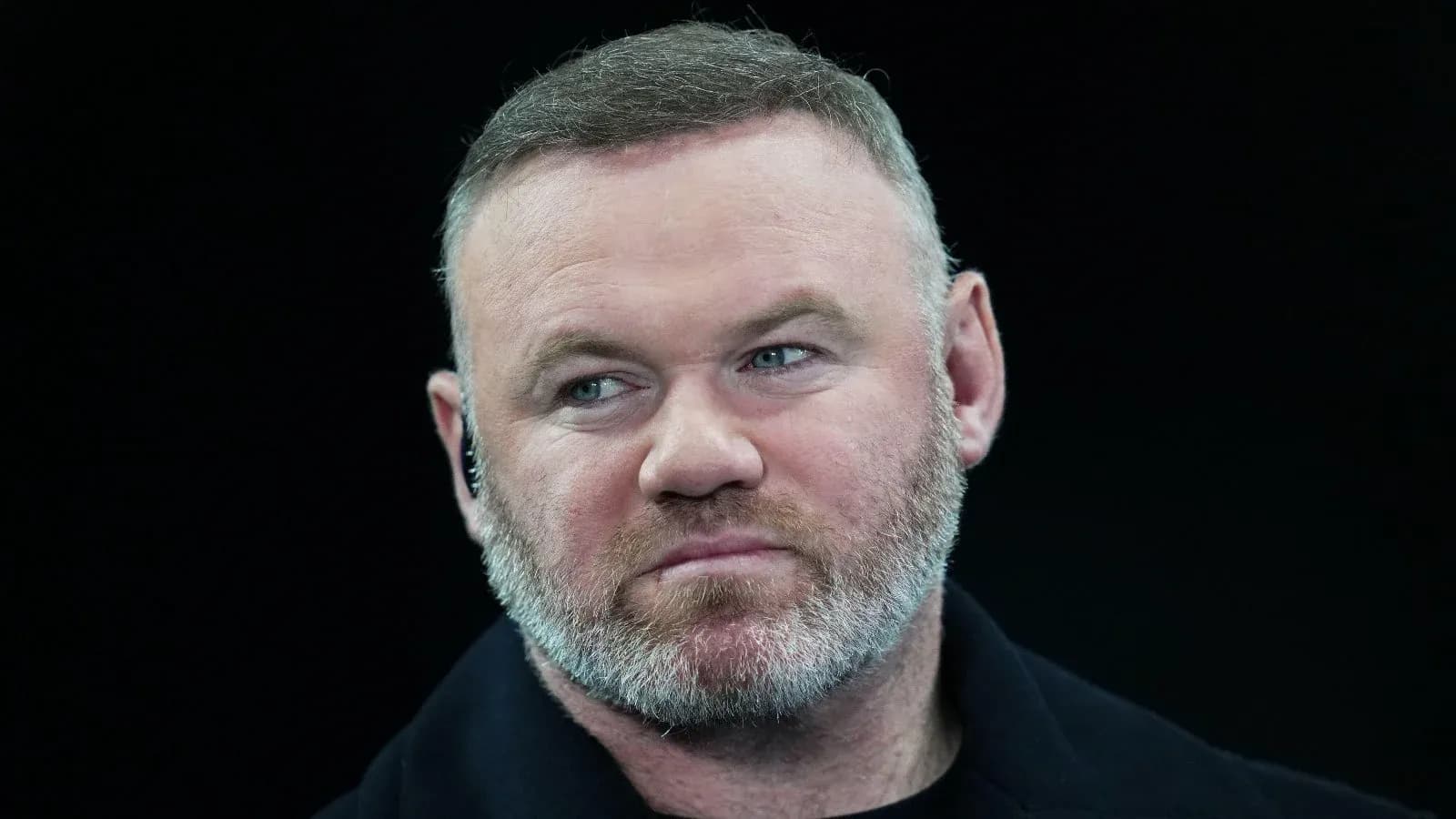 Man with beard speaking at event