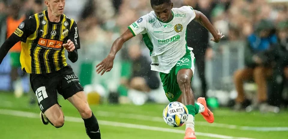 Player dribbling past opponent during a match