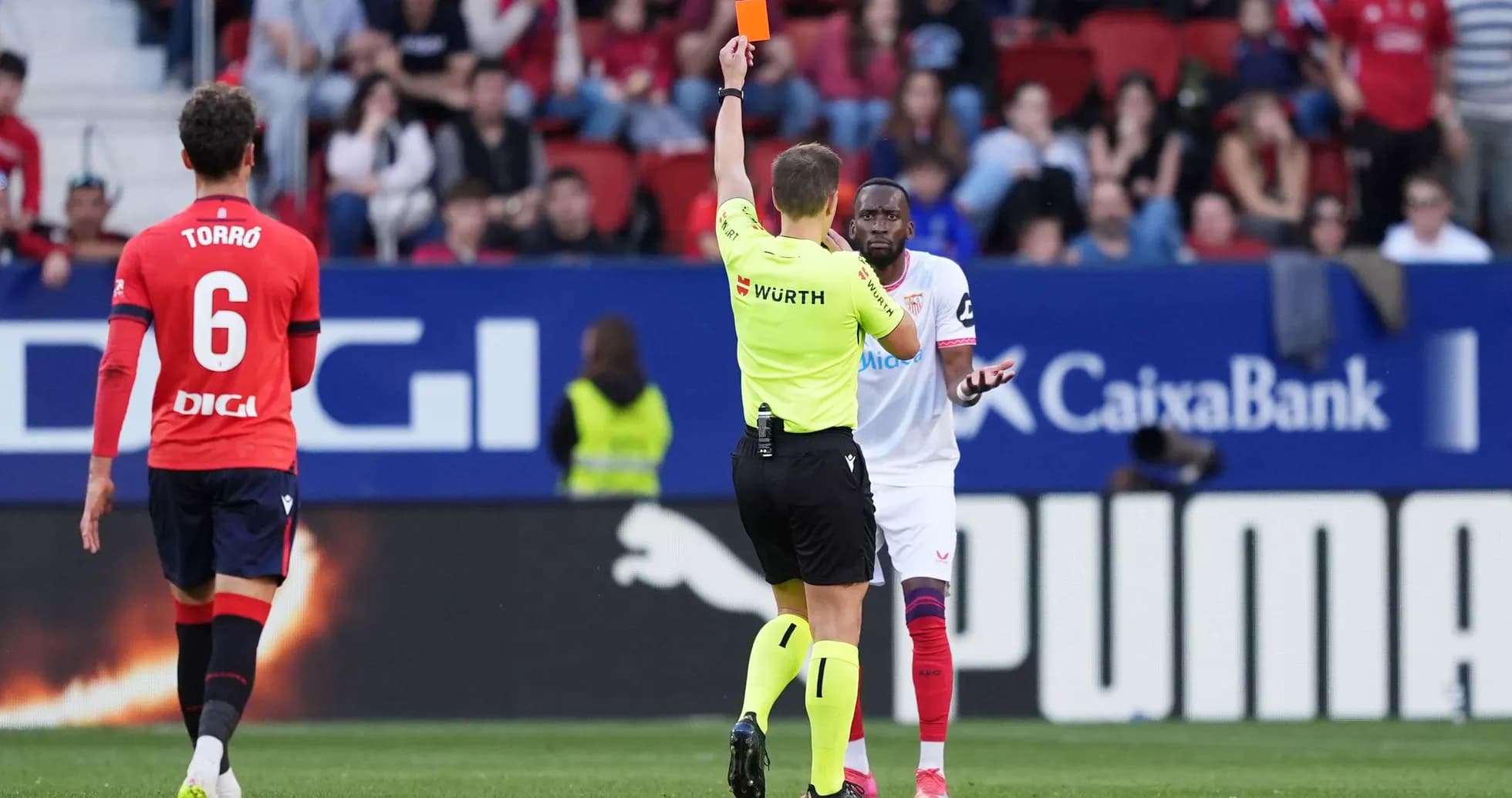 Referee shows red card during Osasuna vs Sevilla match