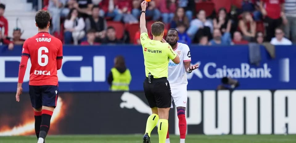 Referee shows red card during Osasuna vs Sevilla match
