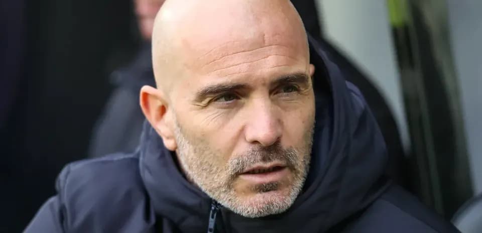 Coach observing from the sidelines during a match