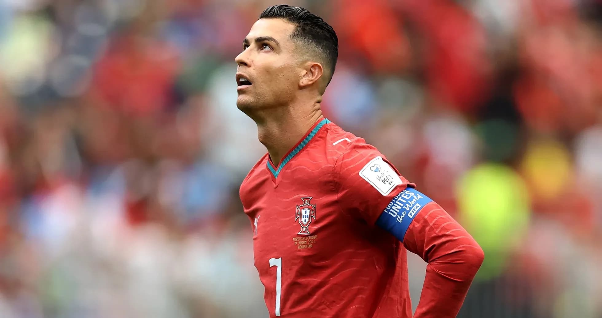 Player in red jersey looking up during match
