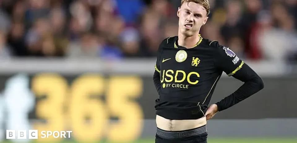 Player adjusting jersey during a football match