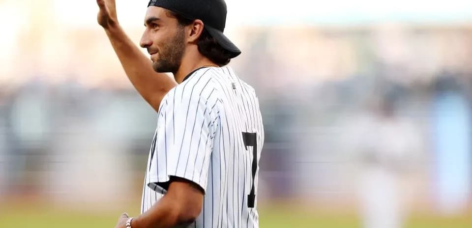 Man in Yankees jersey waving to the crowd