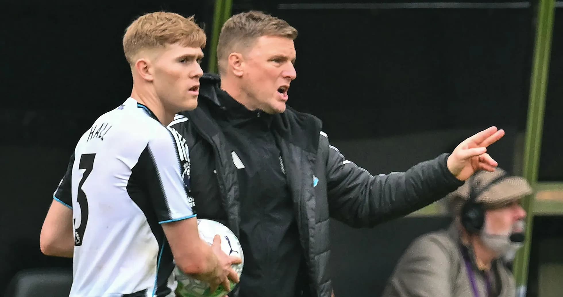 Manager giving instructions to player on sideline