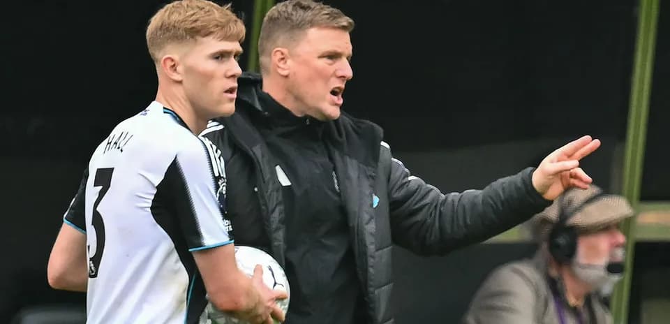 Manager giving instructions to player on sideline