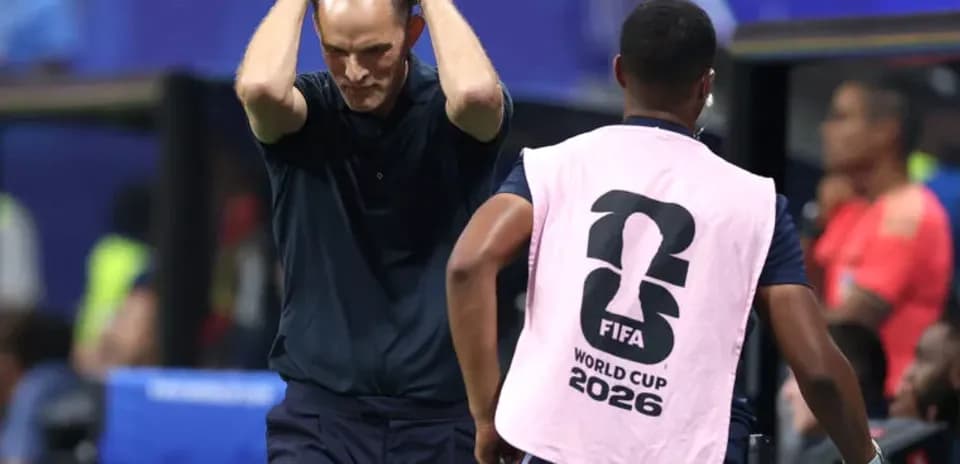 Coach with hands on head during match action