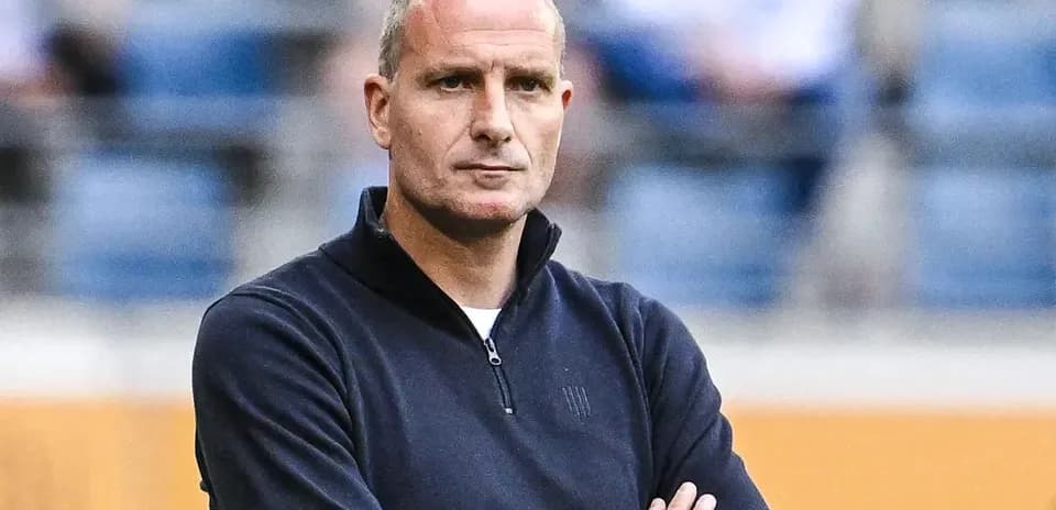 Coach observing the match with arms crossed
