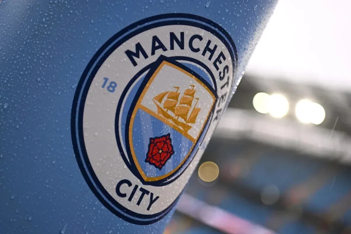 Close-up of Manchester City club logo with raindrops