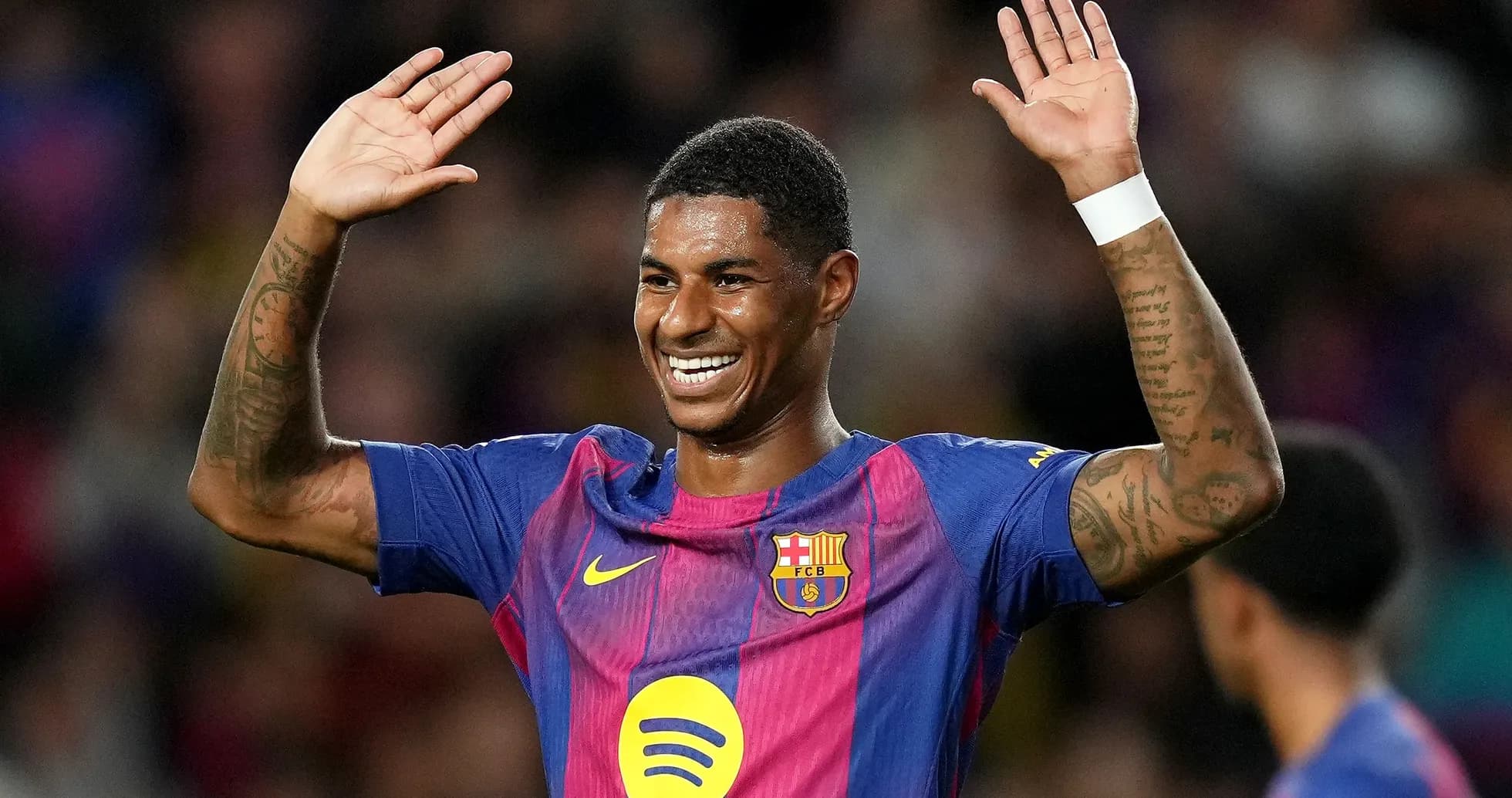 Player celebrating with raised hands on pitch
