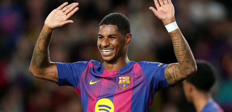 Player celebrating with raised hands on pitch