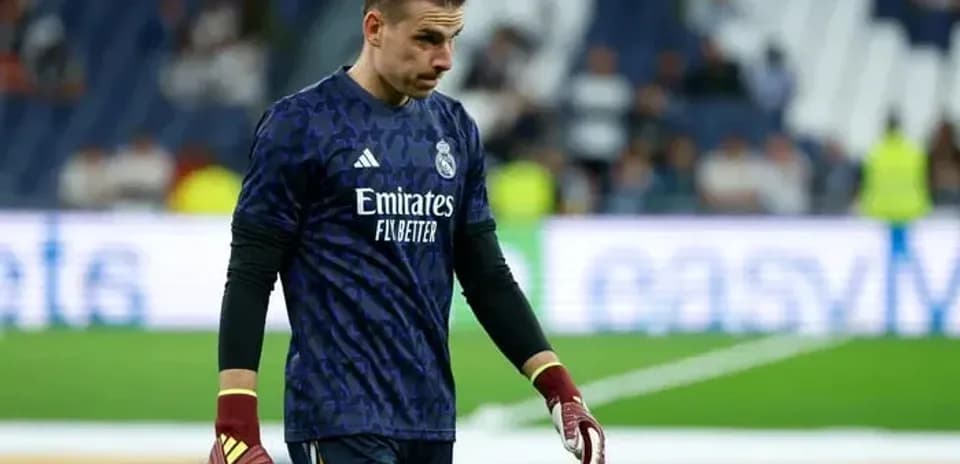 Goalkeeper in Real Madrid kit walking on pitch