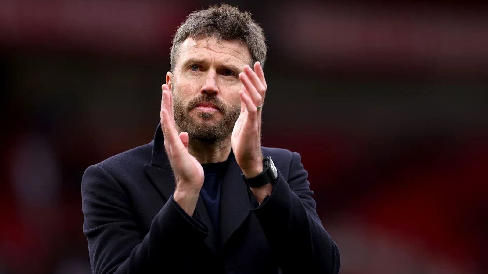 Coach applauding during match at stadium