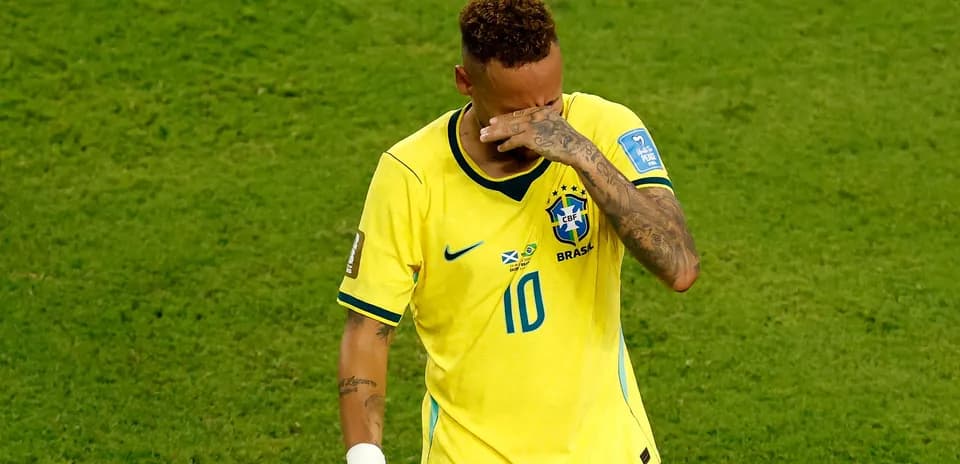 Player in Brazil jersey wiping his face