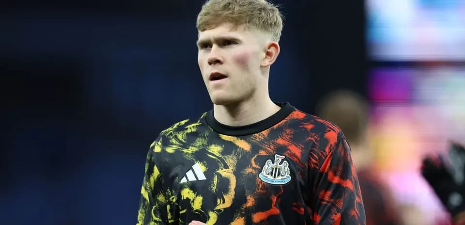 Player wearing Newcastle United warm-up kit before match