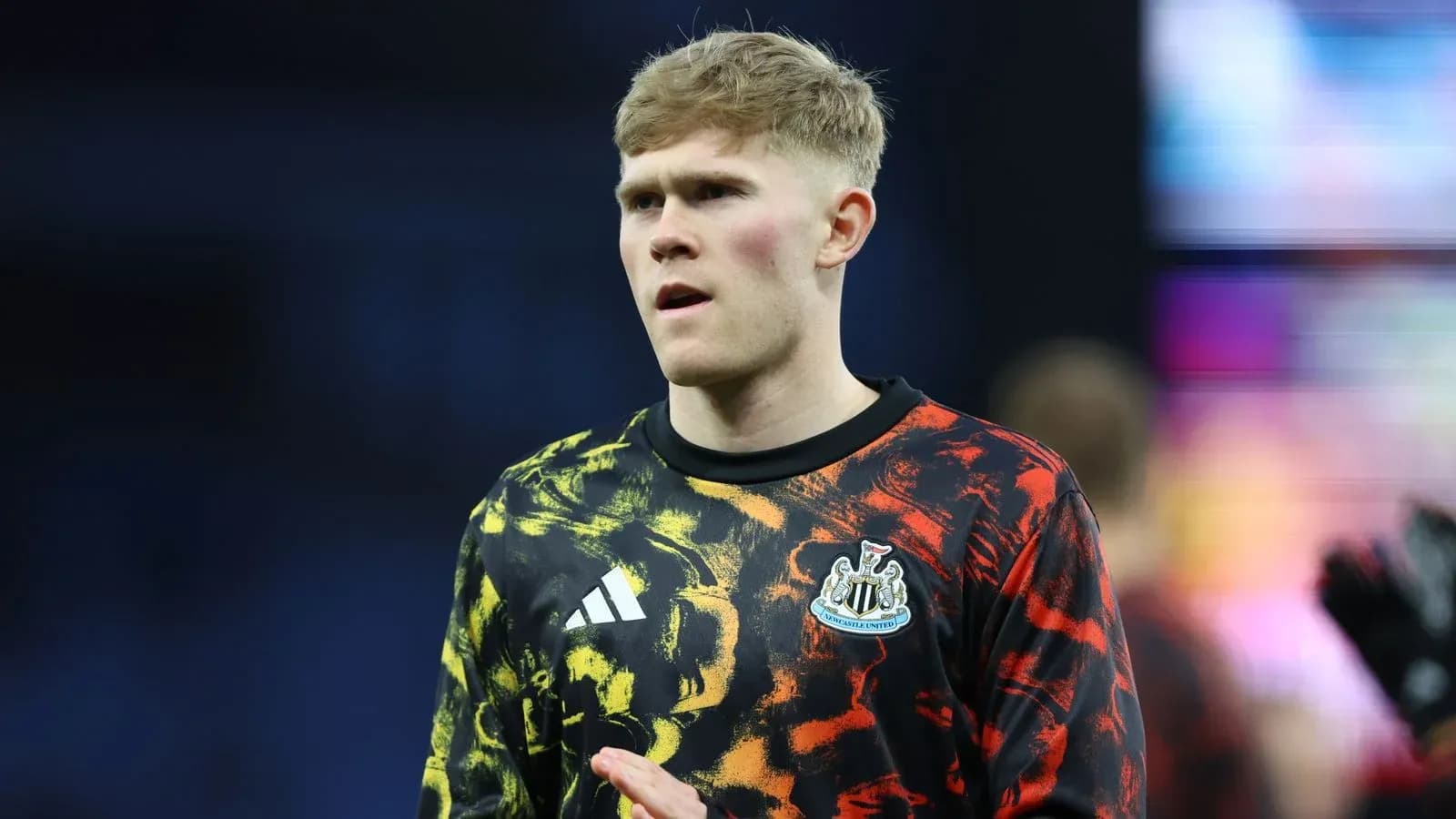 Player wearing Newcastle United warm-up kit before match