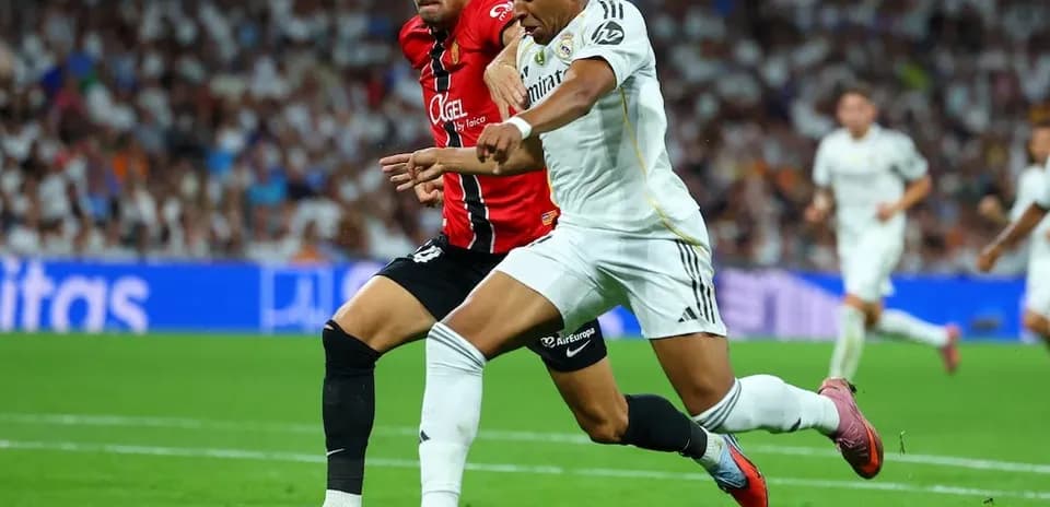 Mallorca player challenging Real Madrid opponent
