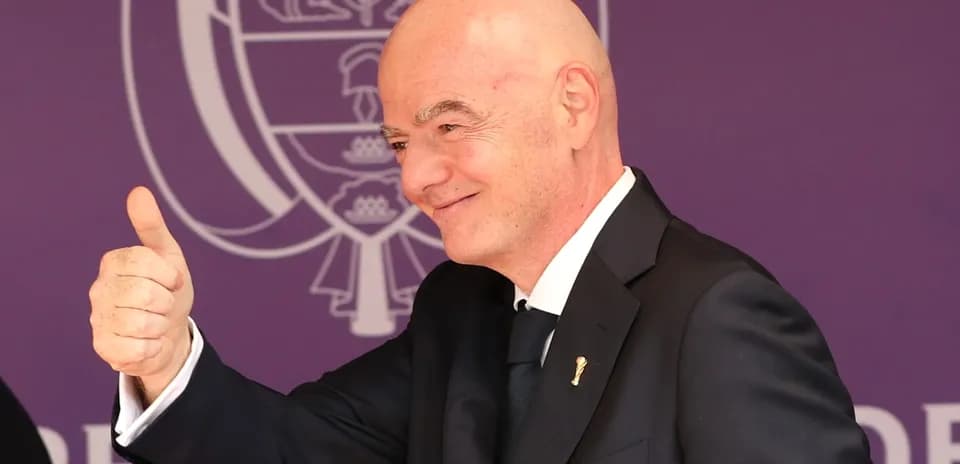 Man giving a thumbs up at event backdrop