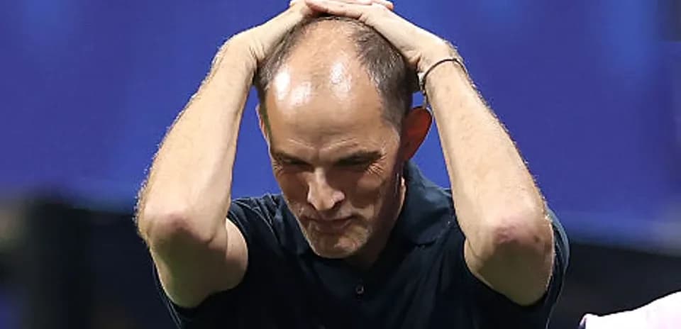 Coach holding head during match reaction