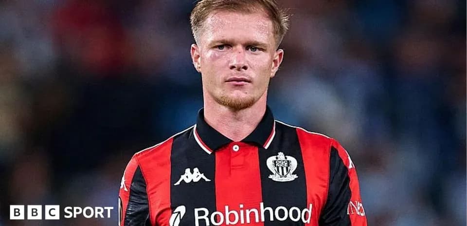 Player in black and red jersey on field