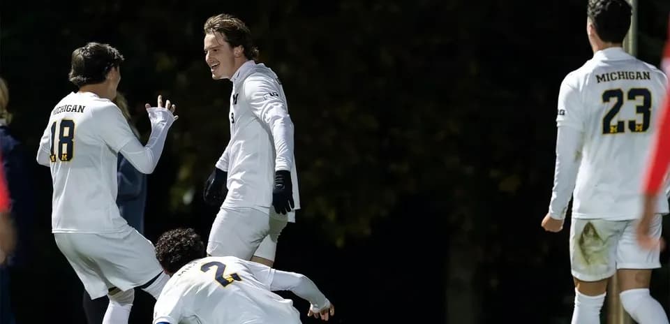 Michigan players celebrating a goal during match