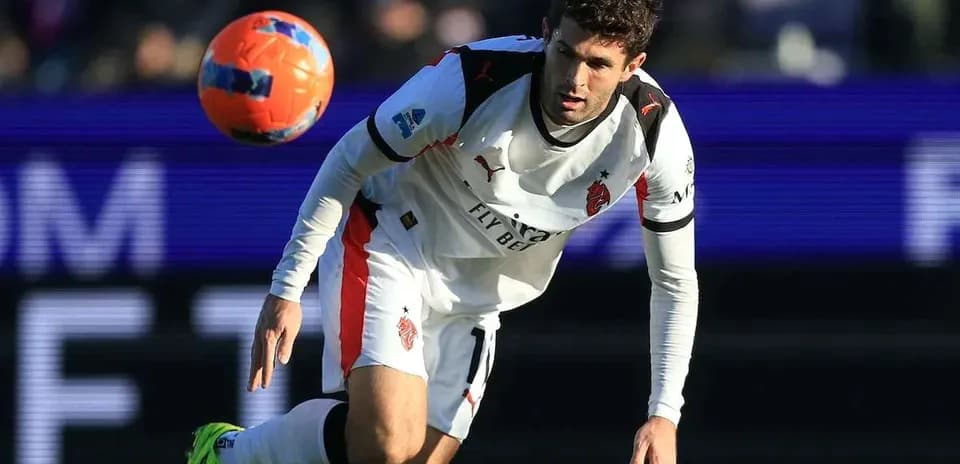 Player in white kit heading the ball during match