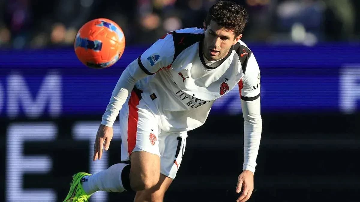 Player in white kit heading the ball during match
