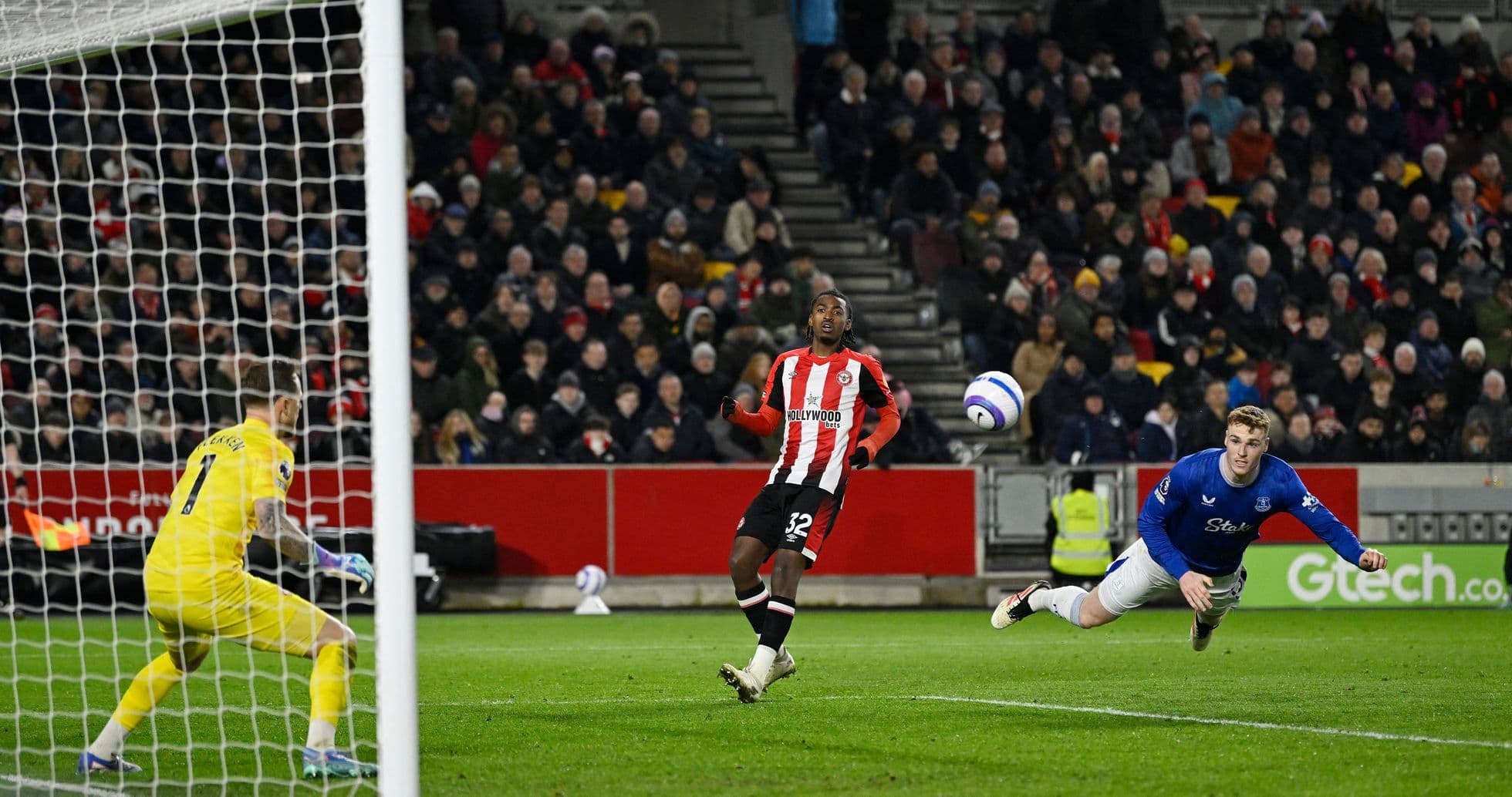 Brentford player attempting to score against Everton