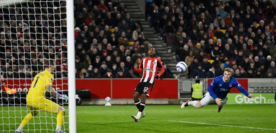 Brentford player attempting to score against Everton