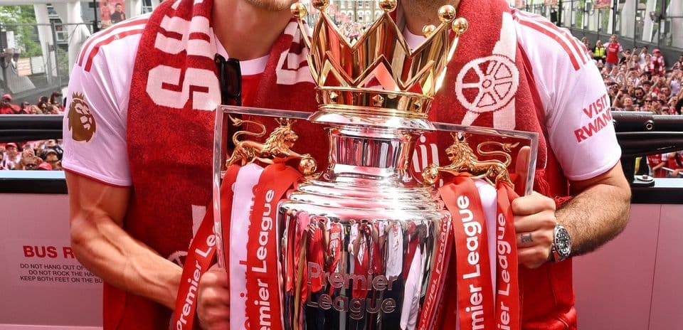 Players celebrating with Premier League trophy on parade