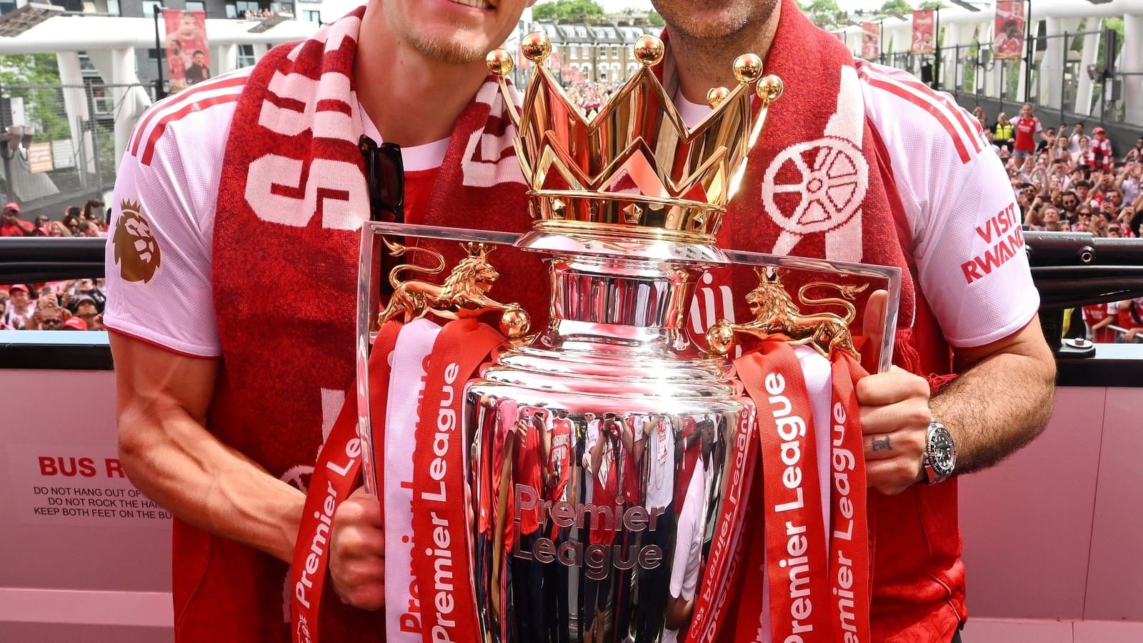 Players celebrating with Premier League trophy on parade
