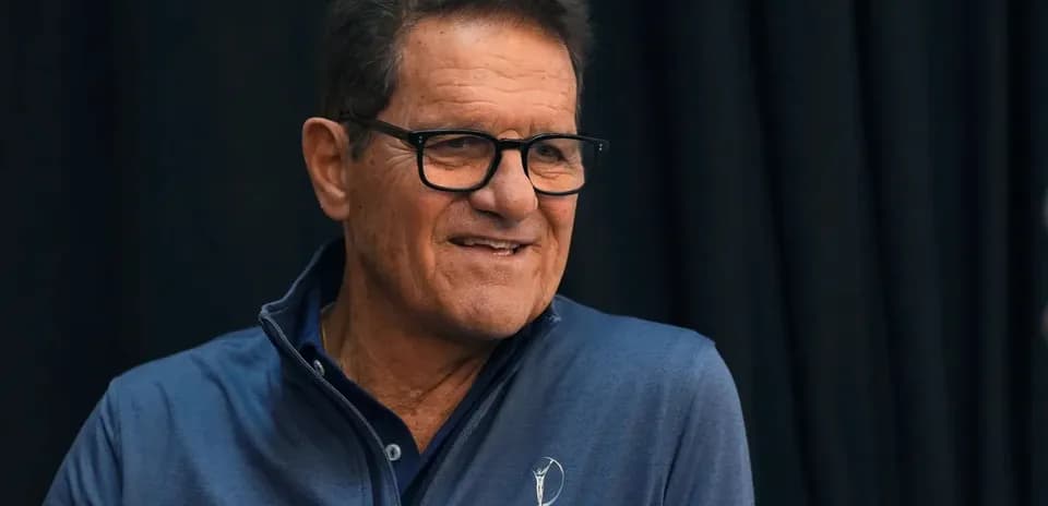 Man in glasses speaking at an event