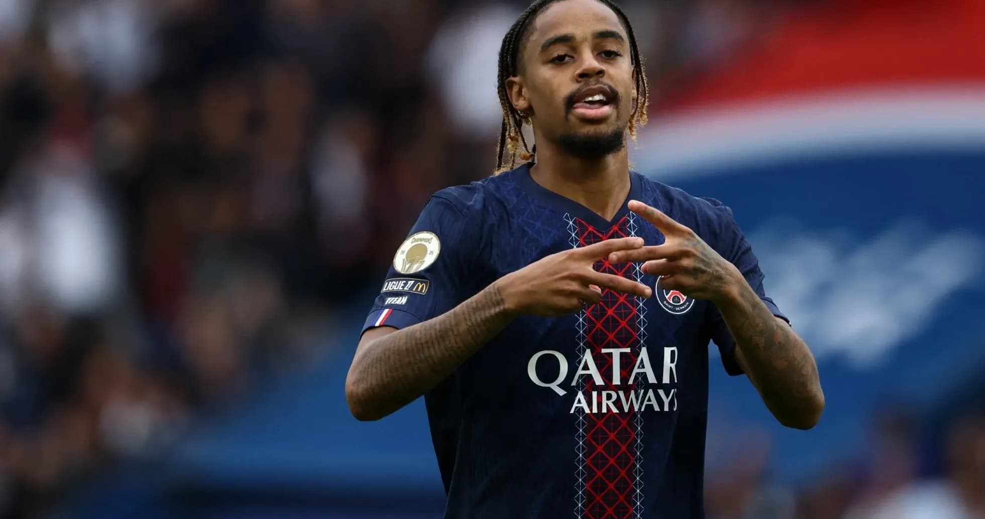 Player gesturing during match in PSG jersey