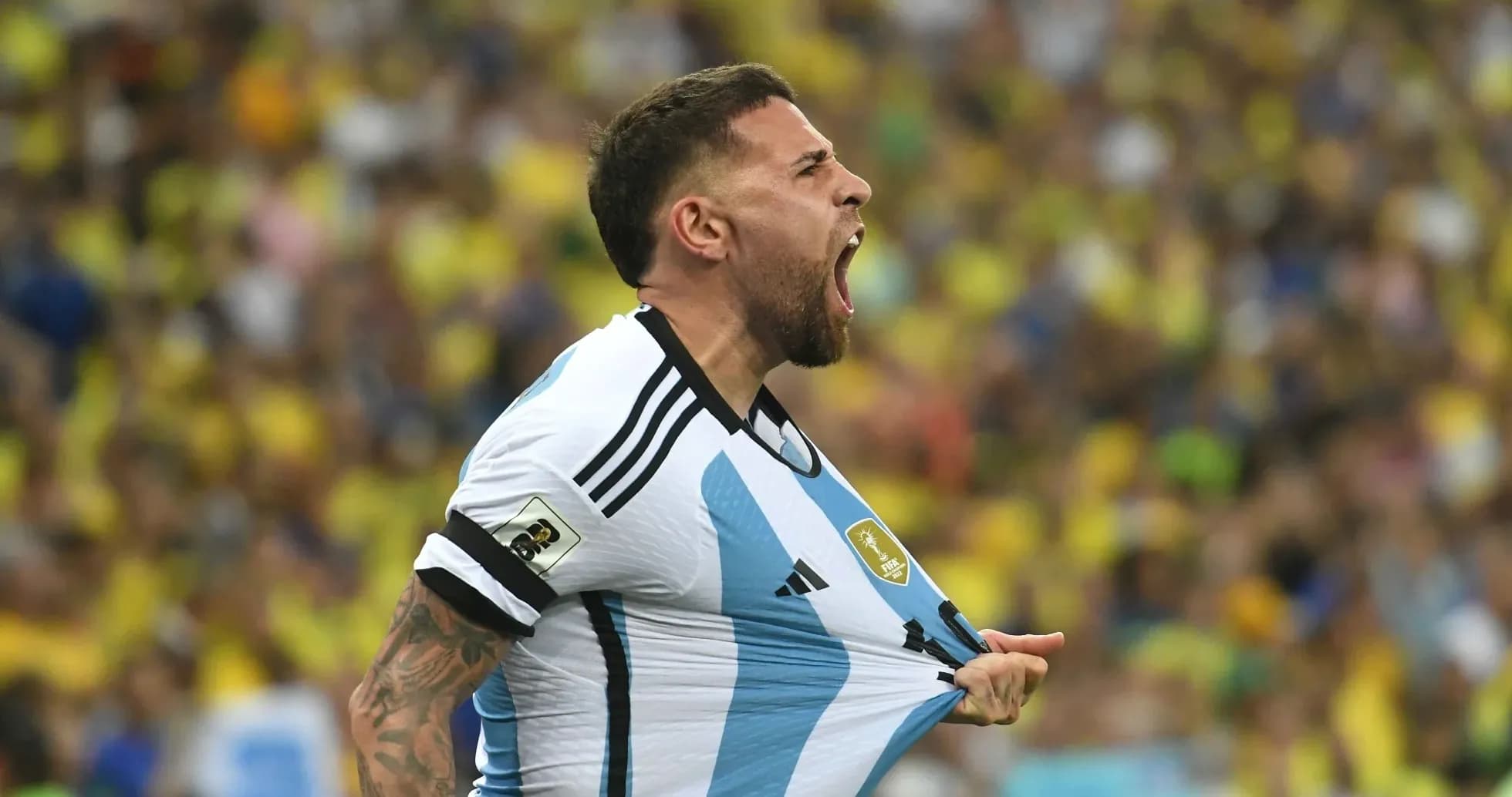 Player celebrating while holding Argentina jersey