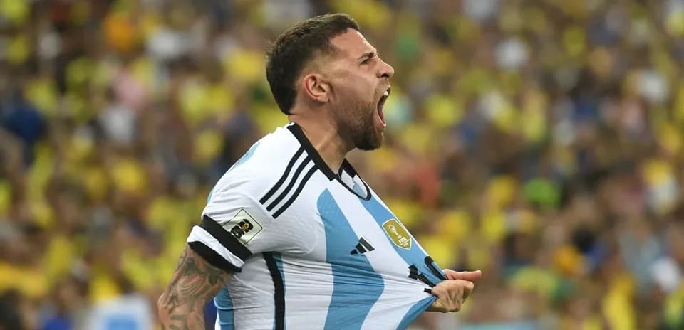 Player celebrating while holding Argentina jersey