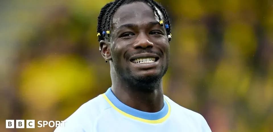Player smiling while wearing a light blue jersey