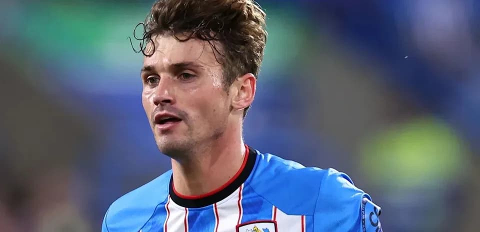 Player wearing blue and white jersey during match