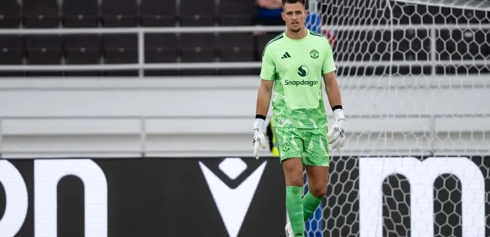 Goalkeeper in green kit standing in goal area