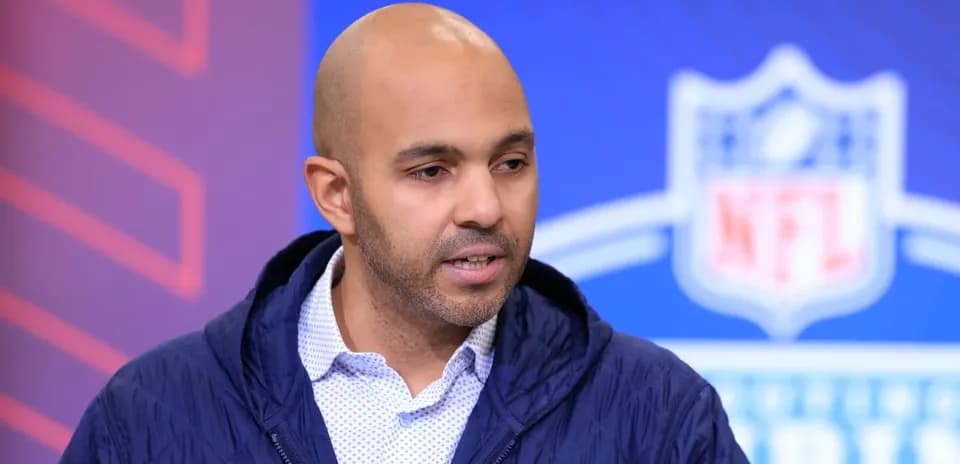 Man speaking at NFL event backdrop