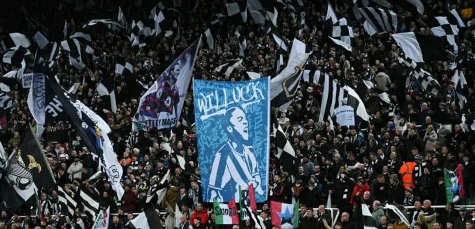 Newcastle United fans waving flags and banners