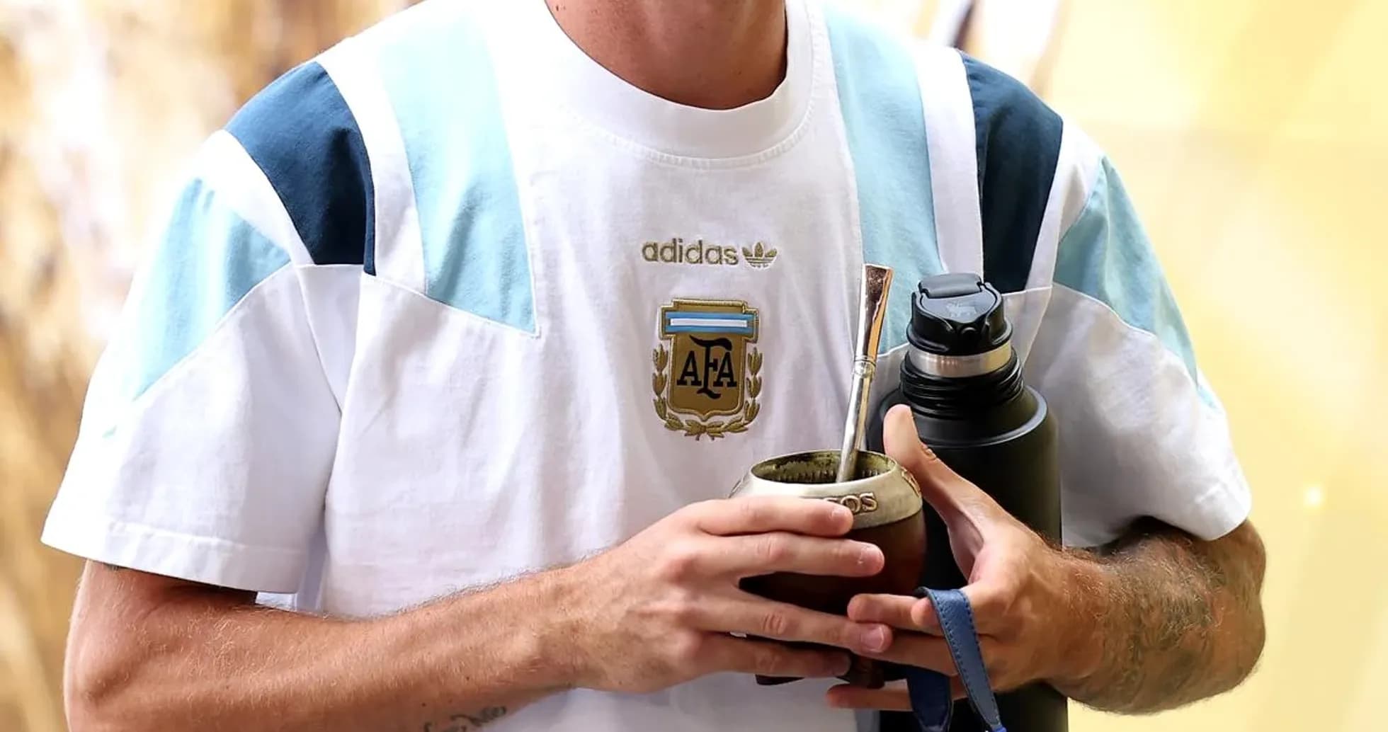 Player holding mate and water bottle at event