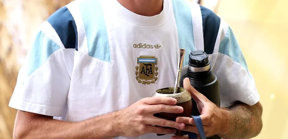 Player holding mate and water bottle at event