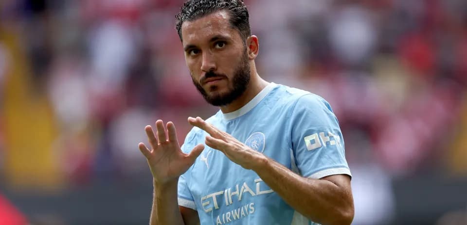 Player gesturing during warm-up on the pitch