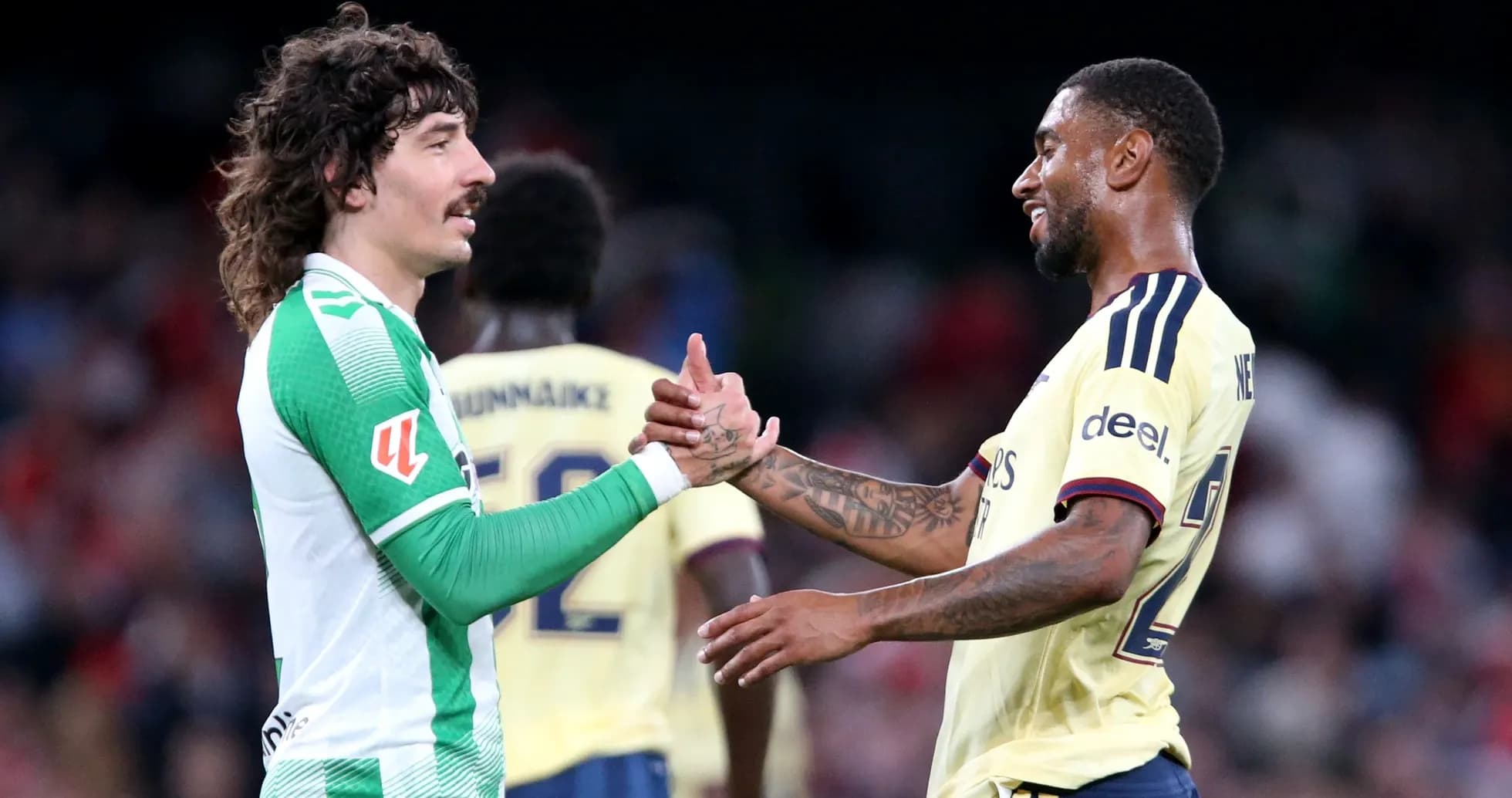 Players shaking hands after match in stadium