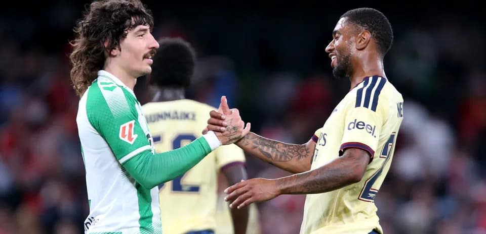Players shaking hands after match in stadium