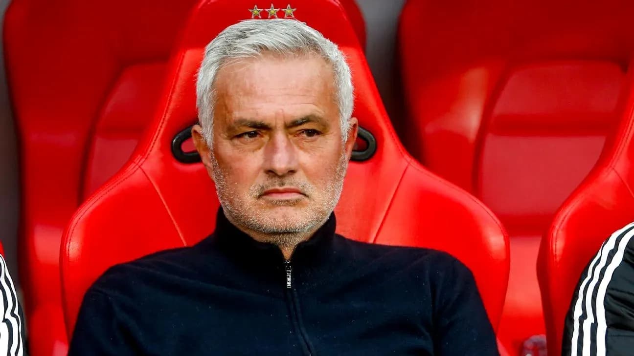 Manager seated on bench during match