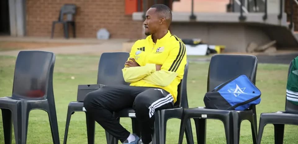 Coach sitting on bench during training session