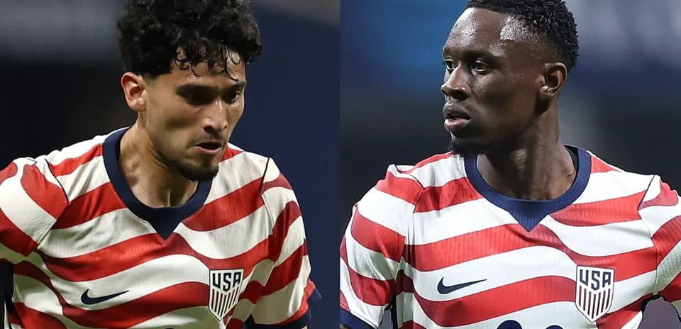 Two USA players in red and white striped jerseys