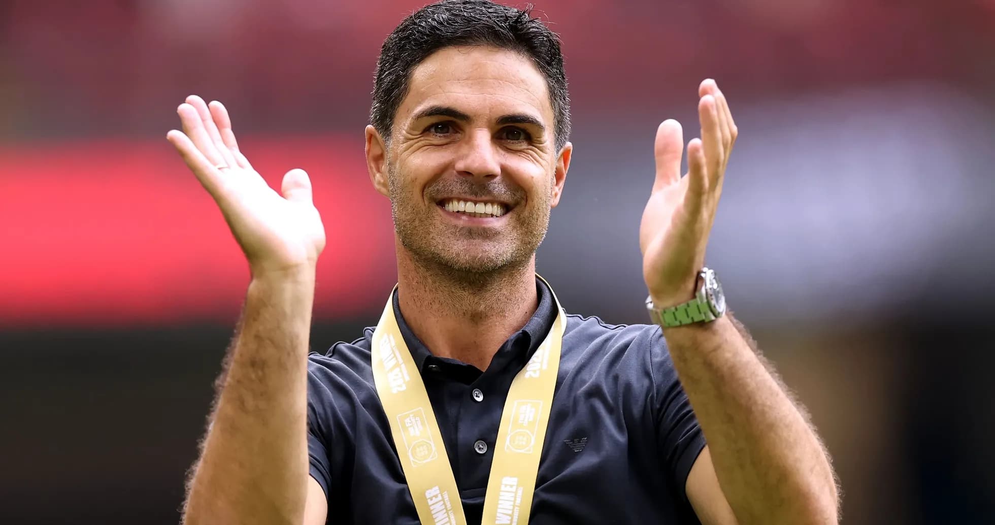 Coach celebrating with medal during victory ceremony